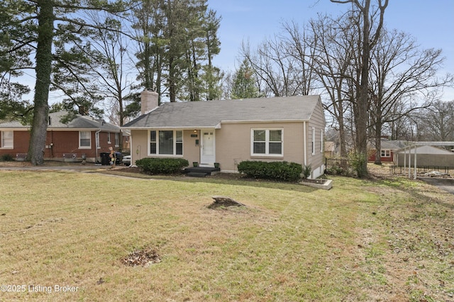 view of front of property with a front yard, brick siding, and a chimney