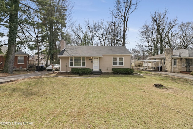 view of front of home featuring a chimney and a front yard