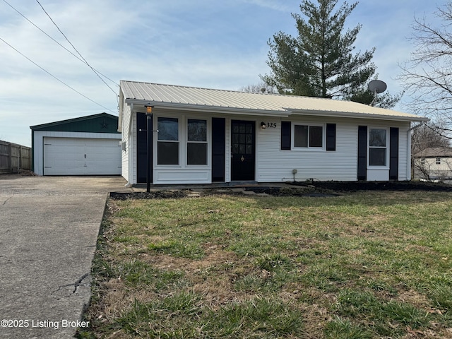 view of front of property featuring covered porch, a front lawn, an outdoor structure, a garage, and metal roof