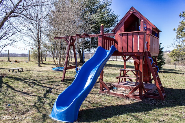 view of jungle gym with a yard and fence