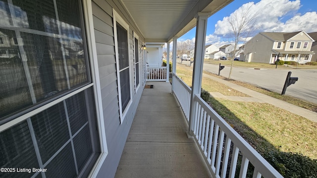 balcony featuring a residential view and covered porch