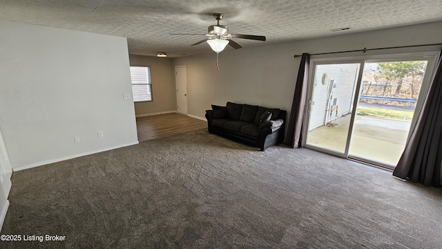 unfurnished room with baseboards, visible vents, a ceiling fan, carpet, and a textured ceiling