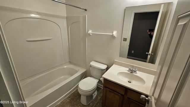 bathroom featuring tile patterned flooring, tub / shower combination, vanity, and toilet