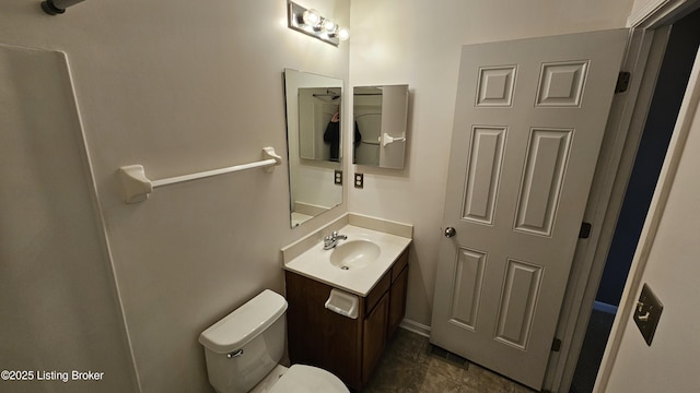 bathroom featuring toilet and vanity