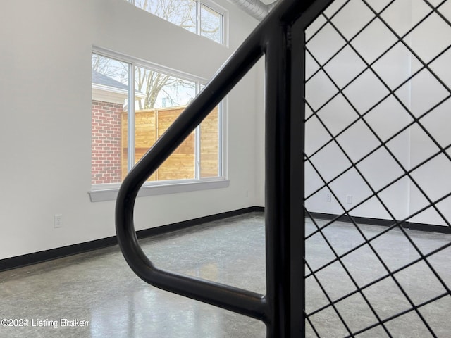 details with baseboards and finished concrete floors