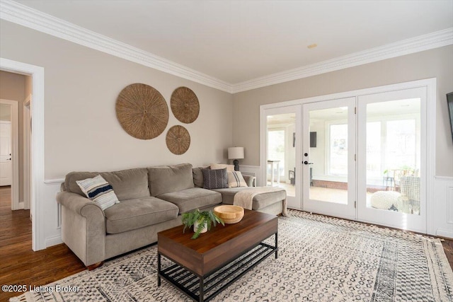 living area with ornamental molding, french doors, and wood finished floors