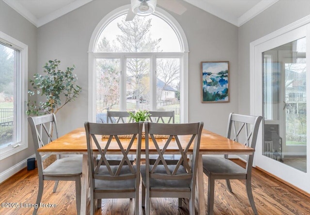 dining room with ceiling fan, vaulted ceiling, crown molding, and wood finished floors