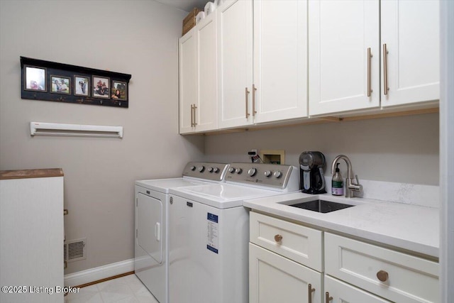 laundry room with separate washer and dryer, a sink, visible vents, baseboards, and cabinet space