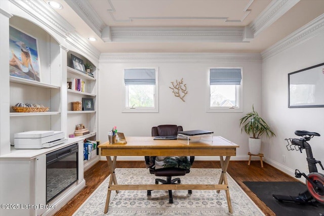 office space with plenty of natural light, ornamental molding, and a raised ceiling