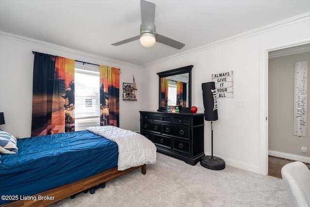 carpeted bedroom with a ceiling fan, multiple windows, baseboards, and crown molding