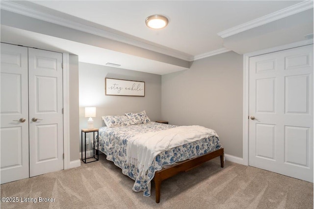 bedroom featuring light carpet, ornamental molding, and baseboards