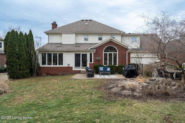 rear view of house with brick siding, a shingled roof, a lawn, a patio area, and an outdoor living space