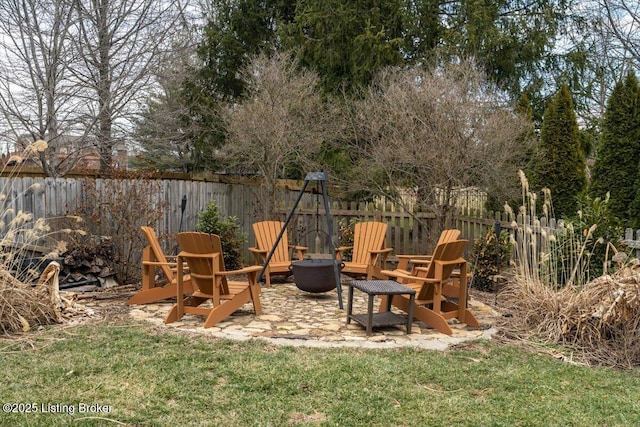 view of yard featuring a patio area, a fenced backyard, and an outdoor fire pit