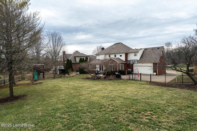 view of yard with concrete driveway and fence private yard