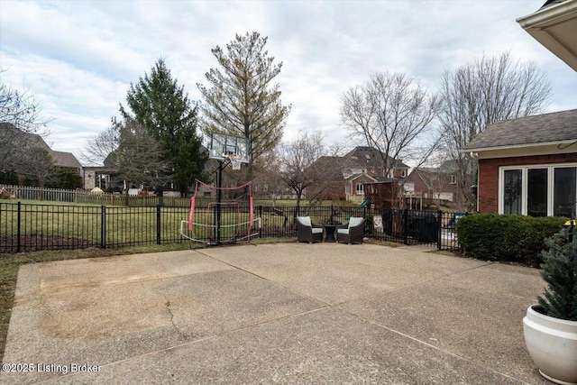 view of patio with basketball hoop and fence