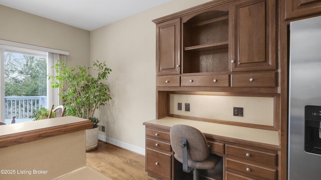 office space featuring light wood-style flooring and baseboards