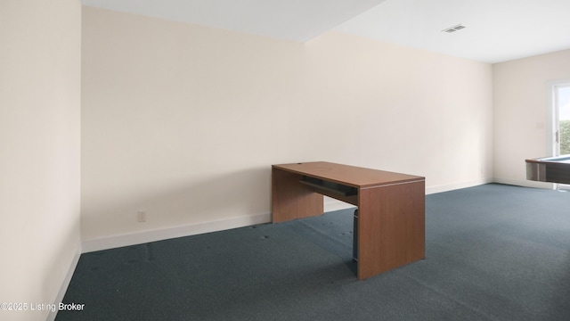 unfurnished office with baseboards, visible vents, and carpet flooring