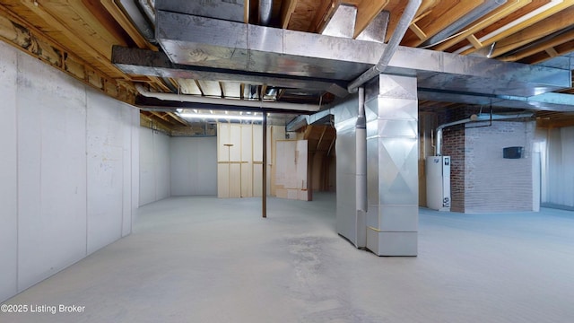 unfinished basement featuring gas water heater