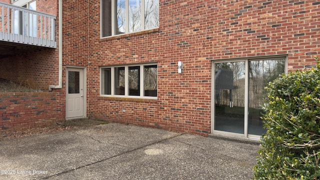 exterior space featuring brick siding