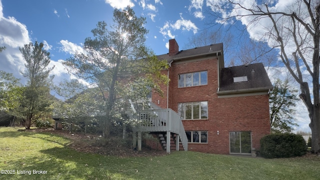 back of house with brick siding, a lawn, and stairs