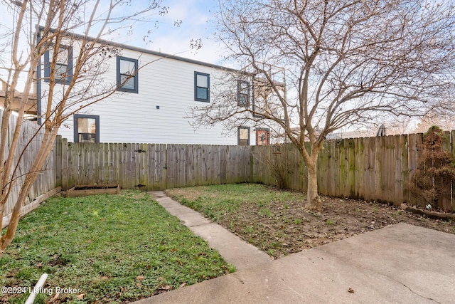 view of yard featuring a patio area and a fenced backyard