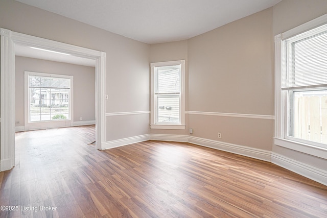 empty room featuring wood finished floors and baseboards