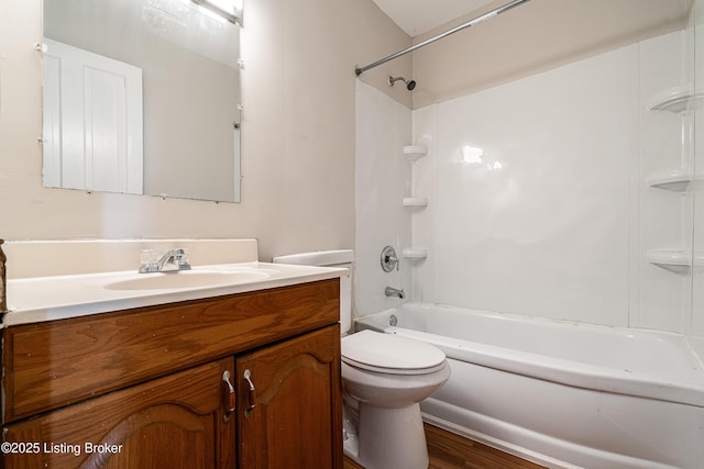 full bath with toilet, shower / bath combination, wood finished floors, and vanity