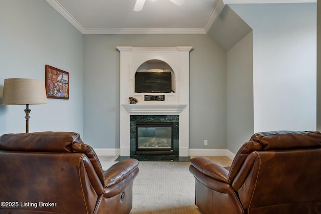 living room with baseboards, carpet floors, a high end fireplace, and crown molding