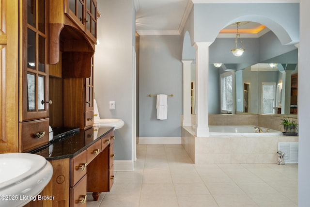 full bath featuring a garden tub, decorative columns, ornamental molding, tile patterned flooring, and baseboards