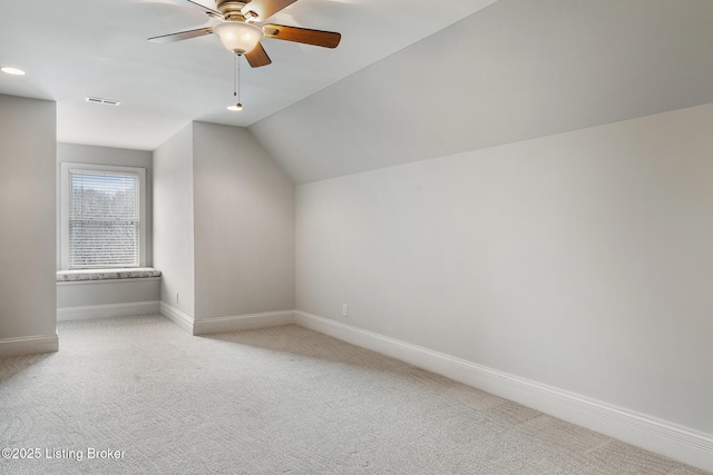 bonus room with lofted ceiling, ceiling fan, carpet floors, visible vents, and baseboards