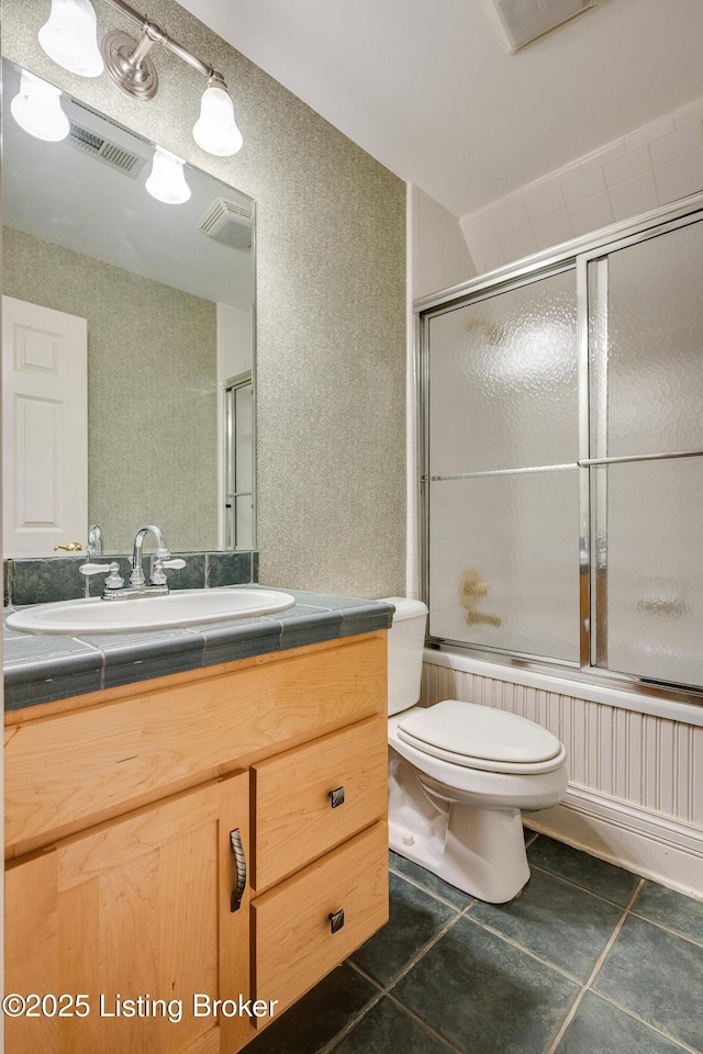 bathroom featuring tile patterned flooring, visible vents, vanity, and toilet