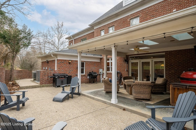 view of patio / terrace with a ceiling fan, fence, area for grilling, and an outdoor hangout area