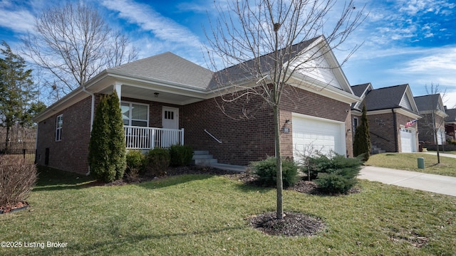 view of front of house with a front lawn, covered porch, concrete driveway, a garage, and brick siding