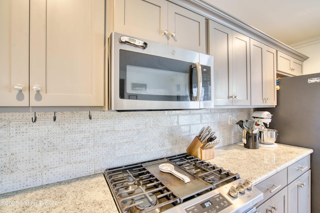 8105 Cedar Crest Ln, Louisville, KY 40291 - kitchen featuring appliances with stainless steel finishes, tasteful backsplash, ornamental molding, and light stone counters
