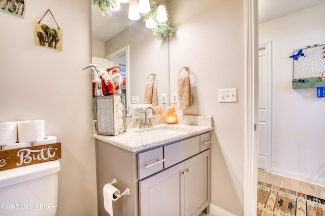 8105 Cedar Crest Ln, Louisville, KY 40291 - bathroom with vanity, toilet, a chandelier, and baseboards