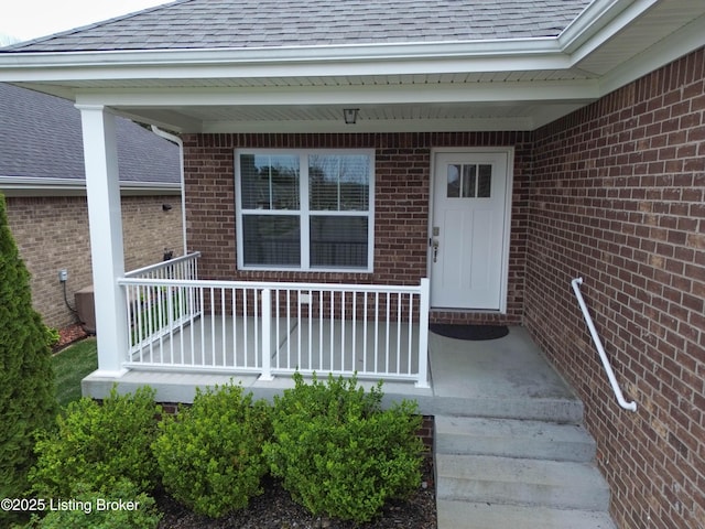8105 Cedar Crest Ln, Louisville, KY 40291 - entrance to property featuring roof with shingles, brick siding, and covered porch