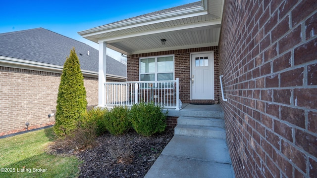 8105 Cedar Crest Ln, Louisville, KY 40291 - view of exterior entry featuring brick siding, covered porch, and a shingled roof
