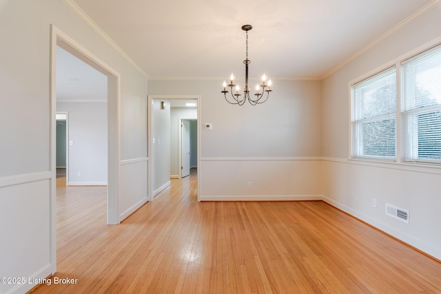 spare room featuring crown molding, visible vents, and light wood-style floors