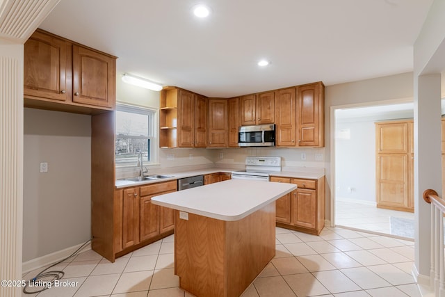 kitchen featuring light tile patterned floors, stainless steel appliances, light countertops, a kitchen island, and a sink