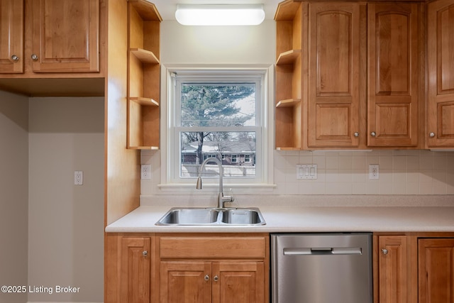 kitchen featuring light countertops, a sink, stainless steel dishwasher, and open shelves