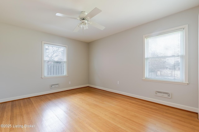 empty room featuring light wood-style floors, baseboards, and a ceiling fan