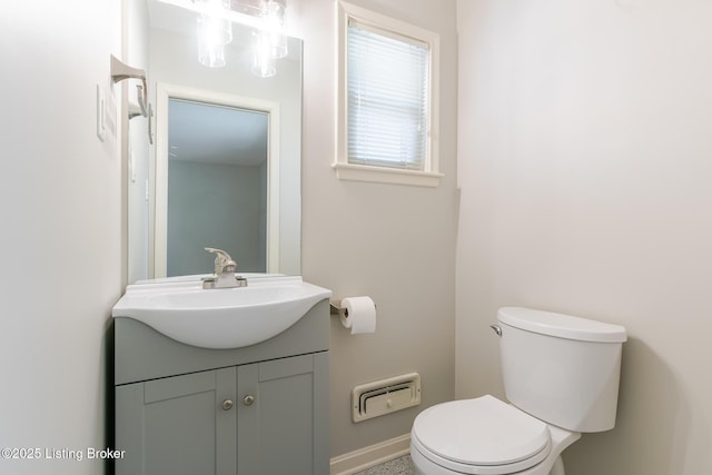 bathroom featuring toilet and vanity