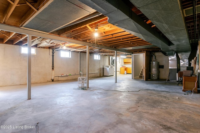 basement featuring water heater and stairway