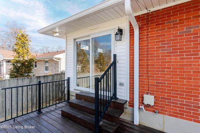 wooden deck featuring entry steps and fence