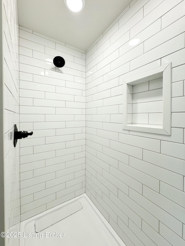 bathroom with a tile shower