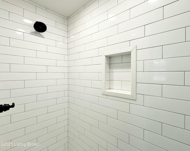 bathroom with a tile shower