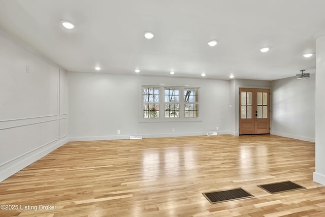 unfurnished room with light wood-style floors, visible vents, and recessed lighting