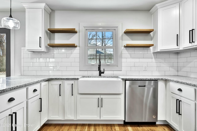 kitchen with a sink, white cabinetry, open shelves, and stainless steel dishwasher