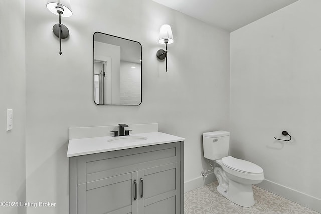 half bath featuring tile patterned flooring, baseboards, vanity, and toilet