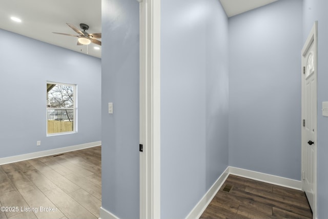 hallway featuring recessed lighting, wood finished floors, and baseboards